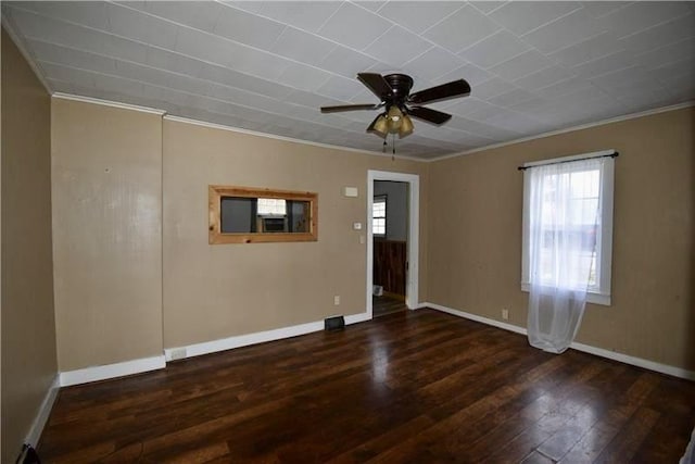 empty room featuring ceiling fan, dark wood-type flooring, and ornamental molding