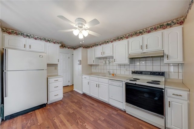 kitchen with white cabinets, sink, and white appliances