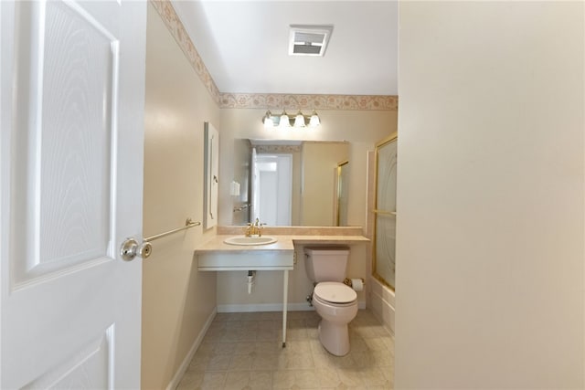 full bathroom featuring toilet, enclosed tub / shower combo, and sink