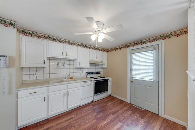 kitchen with white cabinetry, sink, white appliances, and backsplash