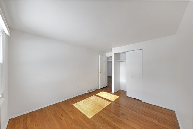 unfurnished bedroom featuring a closet and wood-type flooring