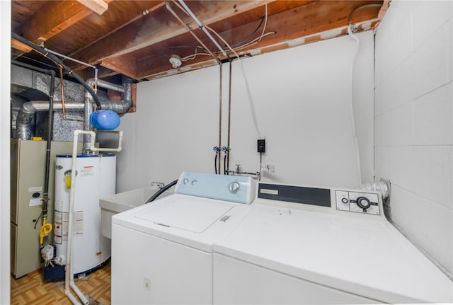 washroom featuring water heater, washer and dryer, heating unit, and light parquet flooring