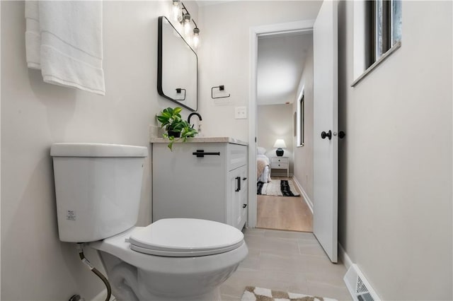 bathroom featuring toilet, tile patterned flooring, and sink