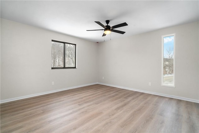 spare room featuring ceiling fan and light hardwood / wood-style flooring