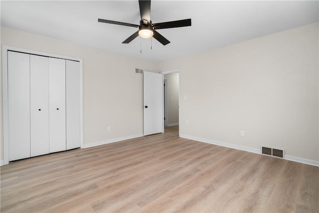 unfurnished bedroom with ceiling fan, a closet, and light hardwood / wood-style flooring