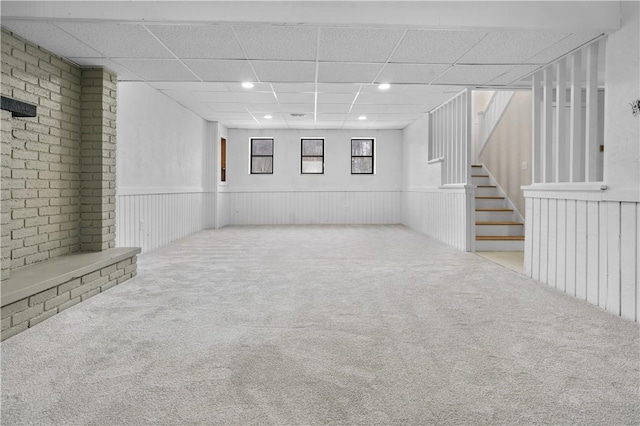 basement with light carpet and a drop ceiling