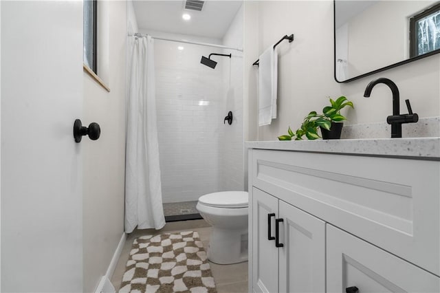 bathroom featuring curtained shower, toilet, and vanity