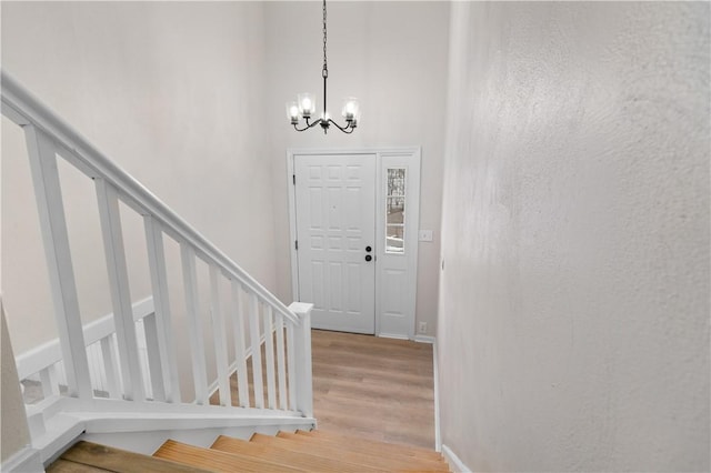 entryway featuring an inviting chandelier and light hardwood / wood-style floors