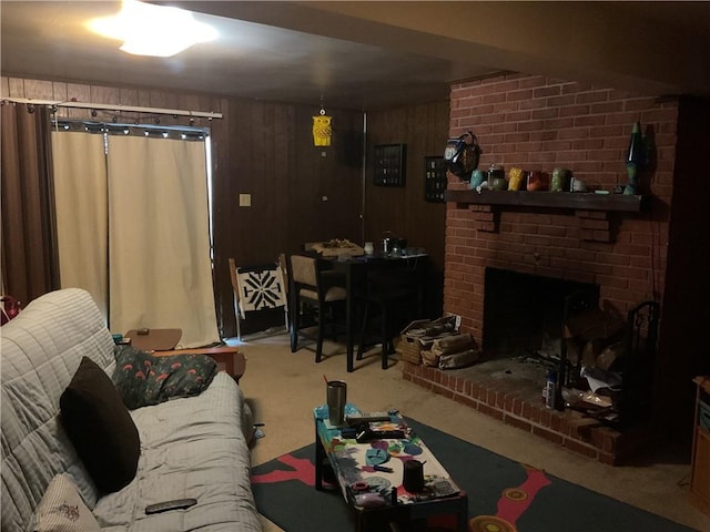 carpeted living room with wood walls and a fireplace