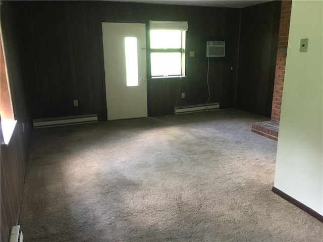 empty room featuring carpet floors, an AC wall unit, and a baseboard radiator