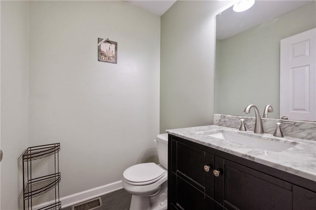 bathroom featuring toilet and vanity