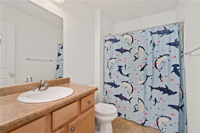 bathroom featuring toilet, vanity, and a shower with curtain