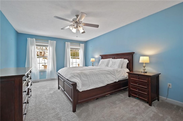 bedroom with ceiling fan and light carpet