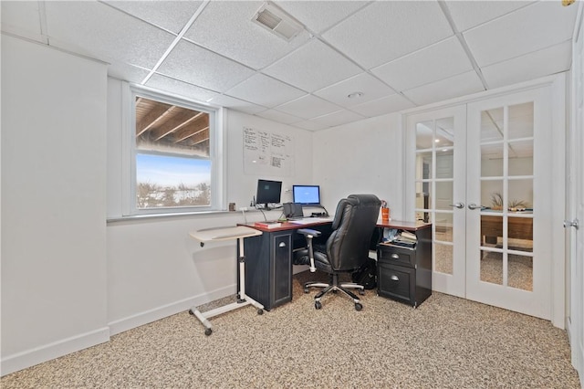 office space with a paneled ceiling, carpet, and french doors