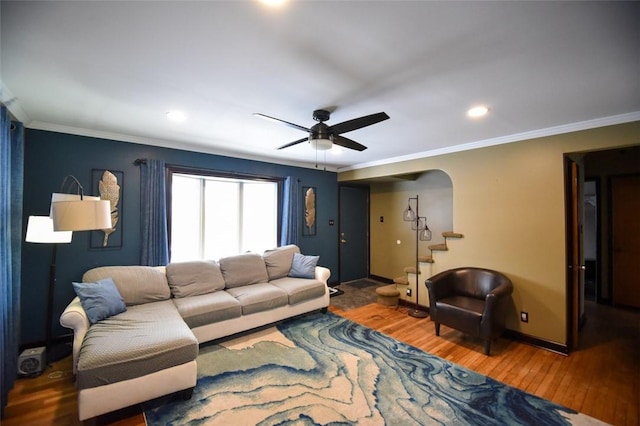 living room with ceiling fan, ornamental molding, and hardwood / wood-style floors