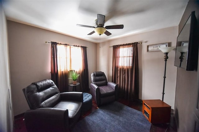 living area with ceiling fan and plenty of natural light