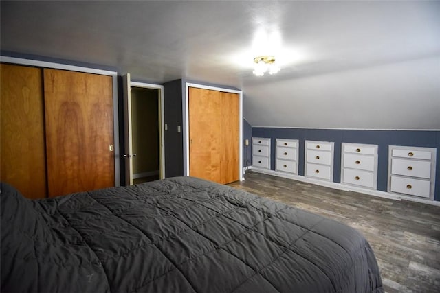 bedroom with lofted ceiling and dark hardwood / wood-style floors