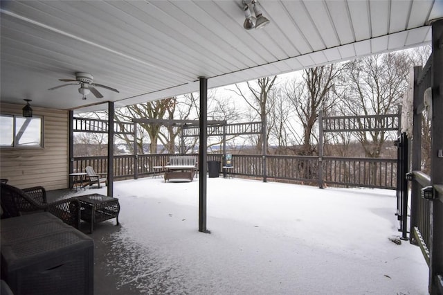 snow covered patio featuring ceiling fan