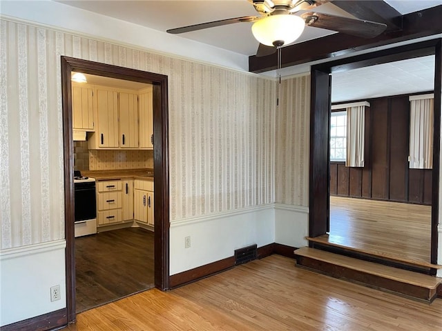 empty room featuring ceiling fan and light hardwood / wood-style floors