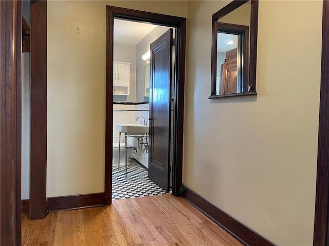 hallway with light hardwood / wood-style floors