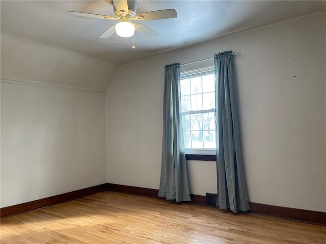 additional living space featuring lofted ceiling, light hardwood / wood-style floors, and ceiling fan