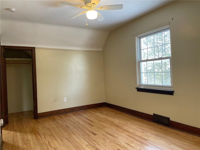 bonus room with ceiling fan, lofted ceiling, and light wood-type flooring