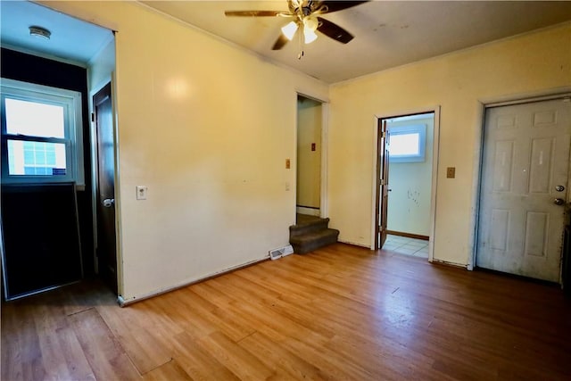 spare room featuring ceiling fan and light hardwood / wood-style floors