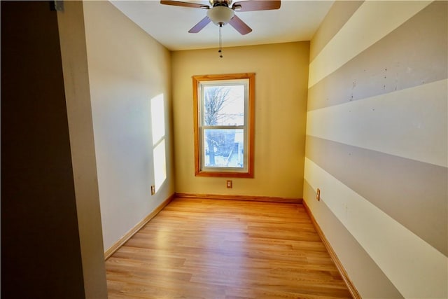 unfurnished room with light wood-type flooring and ceiling fan