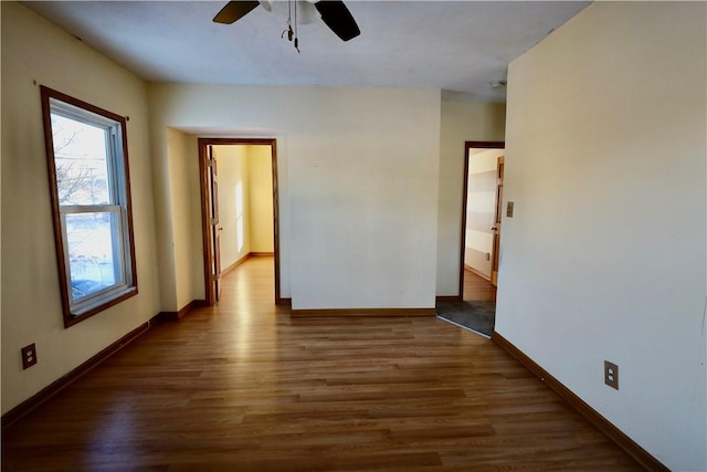 unfurnished room featuring ceiling fan, plenty of natural light, and dark hardwood / wood-style flooring