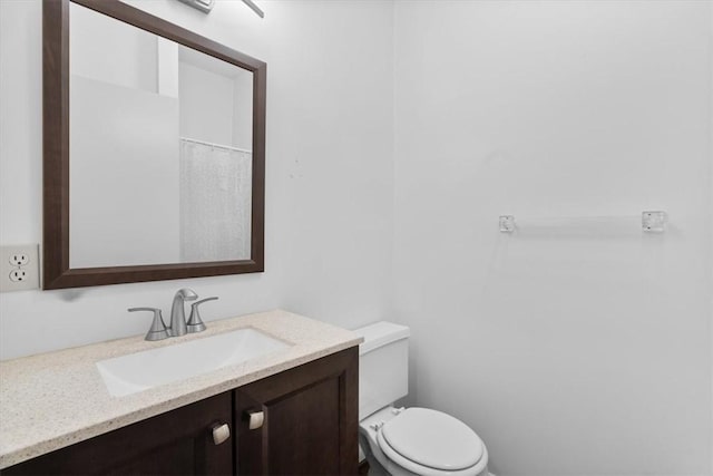 bathroom featuring toilet and vanity