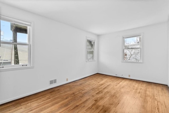 empty room with light hardwood / wood-style flooring