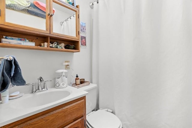 bathroom featuring toilet and vanity