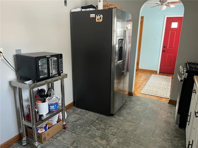 kitchen featuring white cabinetry, ceiling fan, stainless steel fridge with ice dispenser, and stove