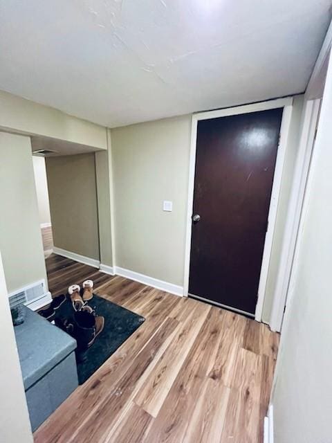 entryway with hardwood / wood-style floors