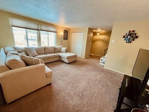 carpeted living room featuring a textured ceiling