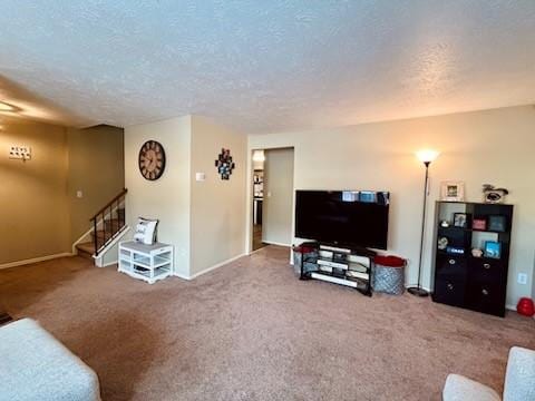 carpeted living room featuring a textured ceiling