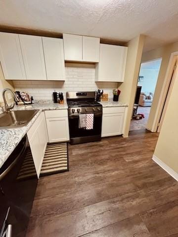 kitchen with sink, dark wood-type flooring, stainless steel range with gas cooktop, and white cabinets