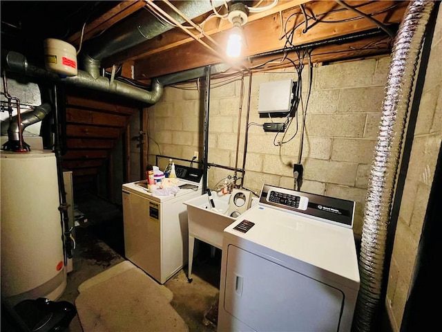 washroom with sink, washing machine and dryer, and water heater