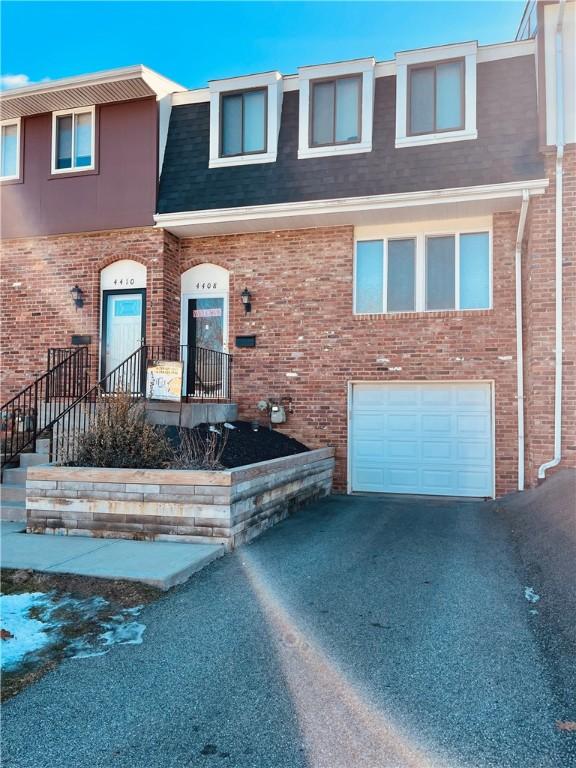 townhome / multi-family property featuring a garage