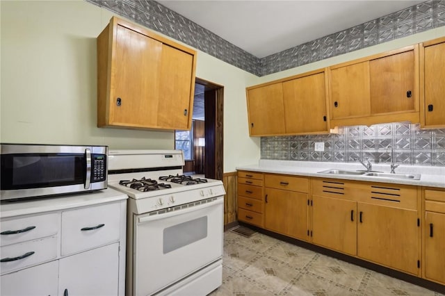 kitchen featuring sink and white gas stove