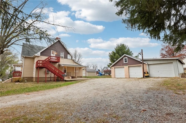 exterior space with a garage and an outbuilding