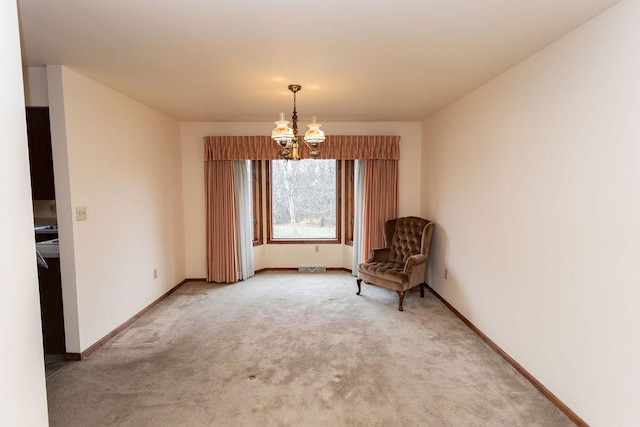 unfurnished room with a chandelier and carpet flooring