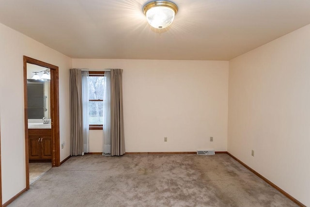 carpeted empty room featuring sink