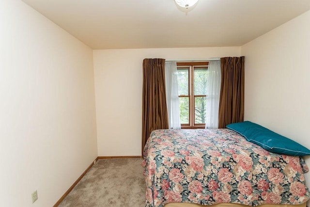 bedroom featuring light carpet