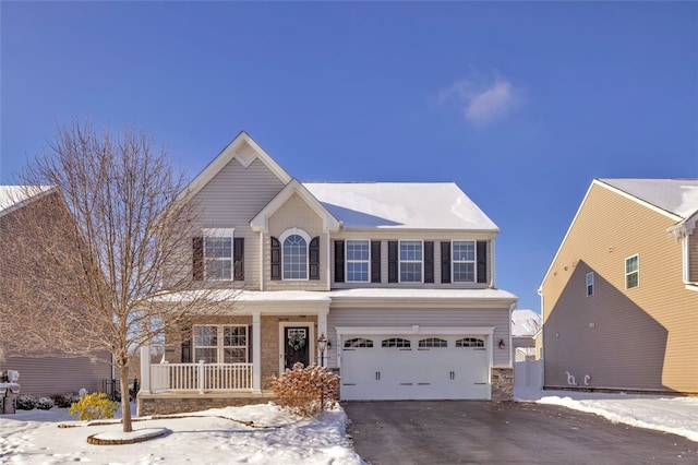 view of front of property featuring a garage and a porch