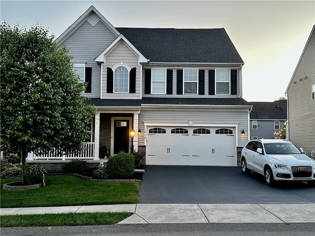 view of front of house with a garage and a front yard