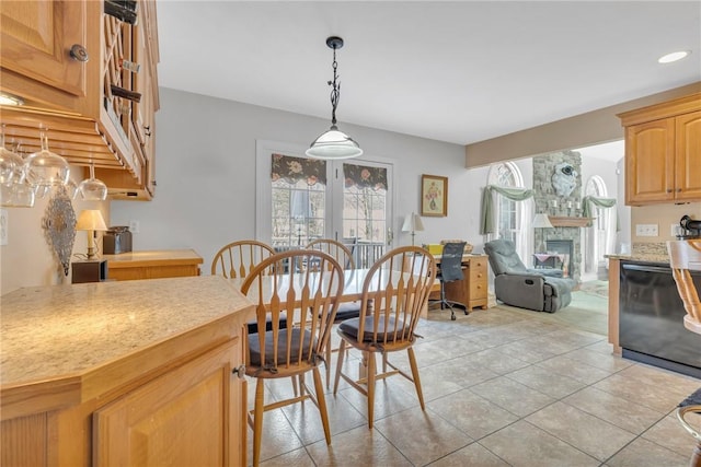 dining area featuring light tile patterned flooring and a fireplace