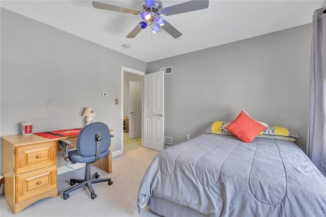 bedroom with ceiling fan and light carpet