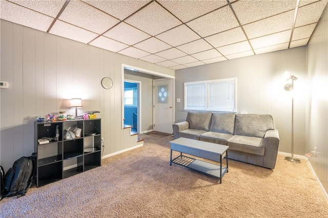 carpeted living room with a paneled ceiling