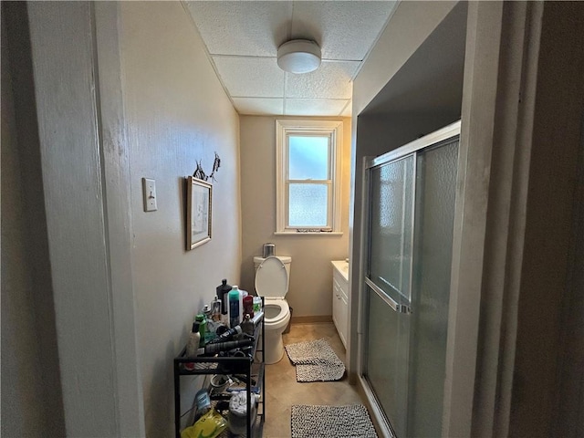 bathroom with an enclosed shower, vanity, and toilet